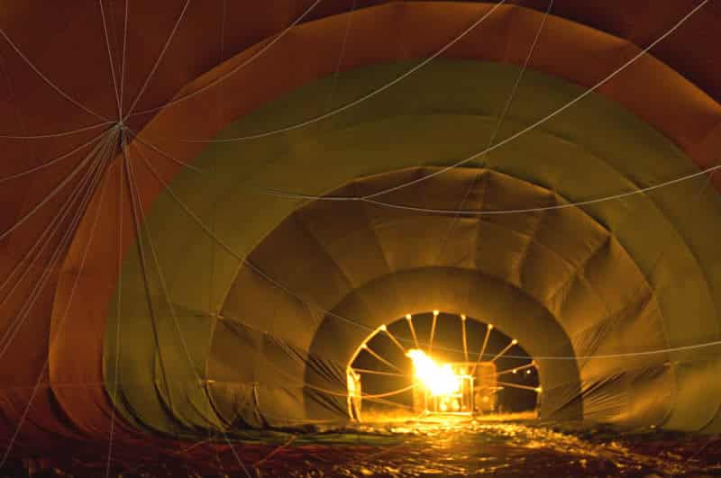 Inflating hot balloon at dawn in the bush